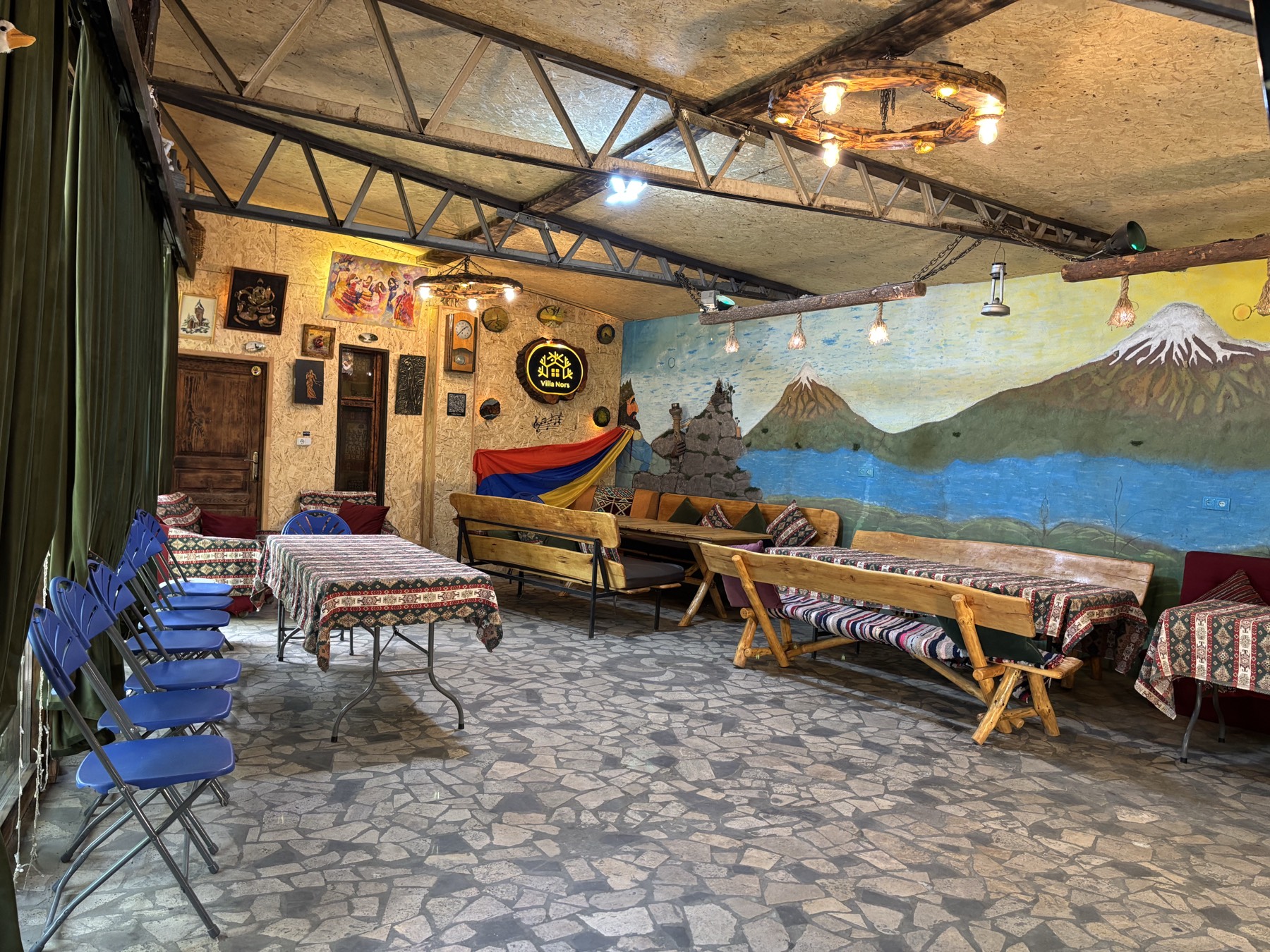 Tables under cloths and folding chairs along the wall, ready for a gathering of up to 50 guests
